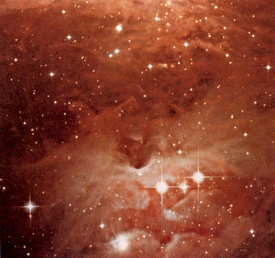 Stars and shining clouds of gas and dust fill the night sky. Those shown here are within the constellation of Orion.